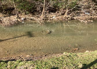 Buchanan County PSA - Collection System Damage - Manhole in creek